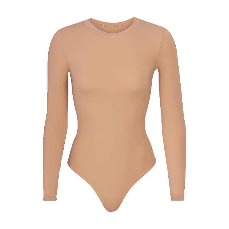 Ruffled Bodysuits with a Playful and Feminine TouchFITS EVERYBODY LONG SLEEVE CREW NECK BODYSUIT | OCHRE
